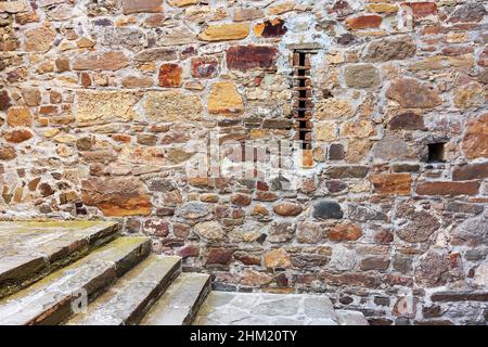 Stone wall background. Background of stone wall of boulders and pebbles Stock Photo