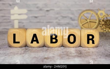 Alphabet letter block in word labor on wood background. Stock Photo