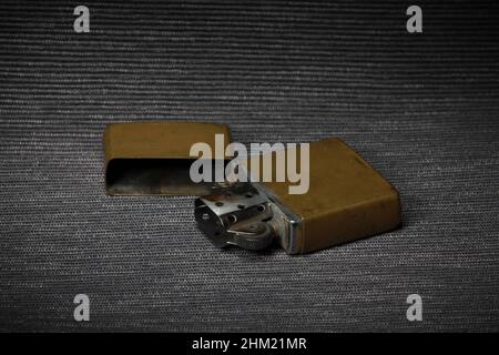 old brass petrol lighter on a dark background close-up, still life Stock Photo