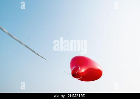 Heart shape balloon against blue sky. copyspace for your individual text. Stock Photo
