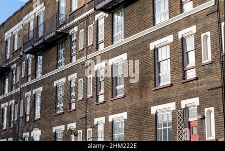A dated terraced block of flats in the East End of London. UK. Originally built to house working class families. Stock Photo