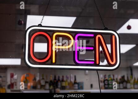 A neon open sign in a shop window. Stock Photo