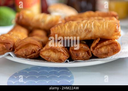A full plate of fried golden, crispy spring rolls. Stock Photo