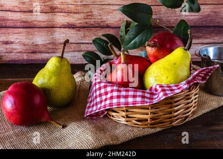 Red battler pears or red pear and packham or green pears in a basket on a table. Organic and natural products. Healt food Stock Photo