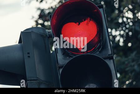 traffic light with red heart-shape in the city Stock Photo