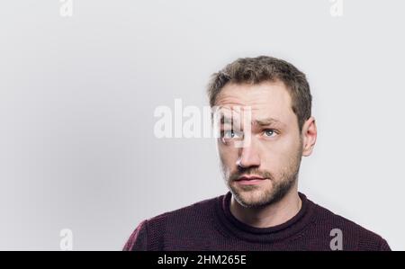 surprised young man looking up Stock Photo