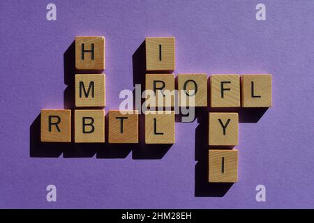 Abbreviations and acronyms, including ROFL, FYI, IRL, HMB and RBTL in crossword form isolated on purple background Stock Photo