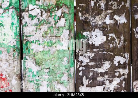 Urban Billboard With Torn Peeled Poster Horizontal Wide Grungy Background. Outdoor Bulletin Board Or Plywood Panel With Worn Advertising Message Notic Stock Photo