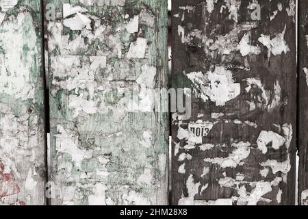 Urban Billboard With Torn Peeled Poster Horizontal Wide Grungy Background. Outdoor Bulletin Board Or Plywood Panel With Worn Advertising Message Notic Stock Photo