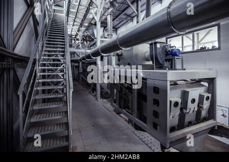Modern grain cleaning and separation equipment in milling factory. Stock Photo