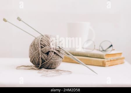 Threads for knitting, from natural environmentally friendly wool, close-up on a light background. Hobby home needlework Stock Photo