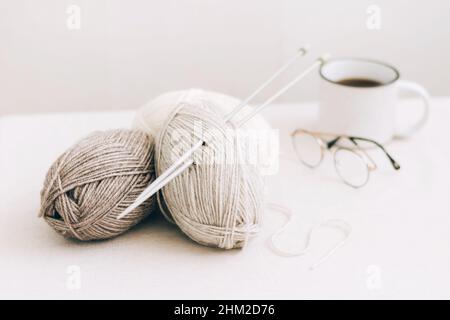 Threads for knitting, from natural environmentally friendly wool, close-up on a light background. Hobby home needlework Stock Photo