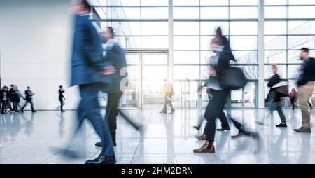abstakt image of business people in the lobby with a blurred background ...