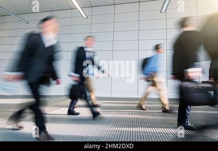 Abstract Image of Business People Walking in a modern office corridor Stock Photo