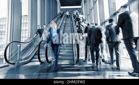 Motion Blurred business on a escalator Stock Photo