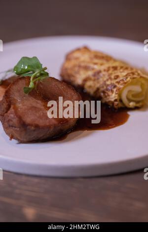 Slow cooked pork collar, cabbage, five spices, apple condiment, fine dining Stock Photo