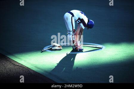 Austin Texas USA: Shaft of sunlight shines on high school baseball player in batter's box during game. ©Bob Daemmrich Stock Photo