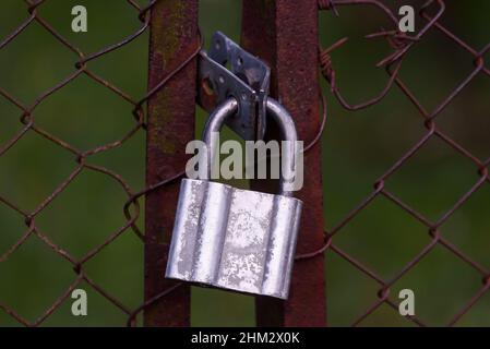 Selective focus photo. Padlock on fence. Stock Photo