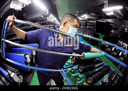 LIANYUNGANG, CHINA - FEBRUARY 7, 2022 - A worker processes spandex products at duzhong Spandex production workshop in Lianyungang Economic and Technol Stock Photo