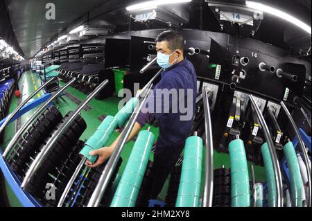 LIANYUNGANG, CHINA - FEBRUARY 7, 2022 - A worker processes spandex products at duzhong Spandex production workshop in Lianyungang Economic and Technol Stock Photo
