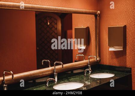 Classic modern washbasins with chrome touch water tap and soap dish. Stock Photo