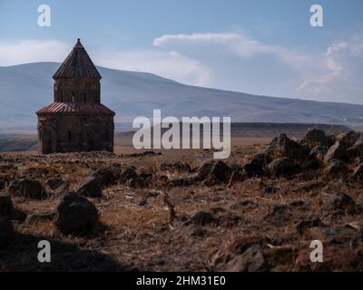 In the ruins of the ancient Armenian capital of Ani, St Gregory of the Abughamrents church sits amongst a dramatic landscape Stock Photo