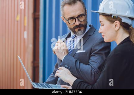 Business man working with women team or secretary in port cargo logistics industry Stock Photo