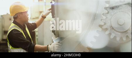 Professional work man engineer worker operate maintenance machine in industry factory wide space for banner background Stock Photo