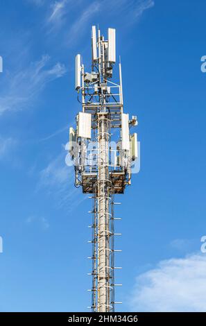 Radio communications tower against a blue sky Stock Photo