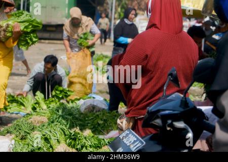 Lampung, Indonesia, February 06 2022- Focus on backward people. buying and selling activities in traditional markets Stock Photo