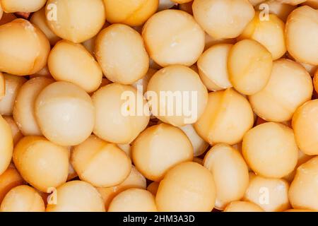 Macadamia nuts close-up harvest cleaned ready for food markets. Stock Photo