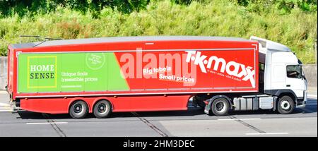 Multi business Home Sense & T K Maxx advertising on side of articulated supply chain trailer with white Volvo hgv lorry truck & driver on UK motorway Stock Photo