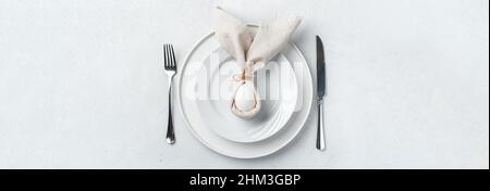 Easter bunny made of napkins and eggs on plates. Top view. The concept of a Happy Easter. Abstract background. Stock Photo