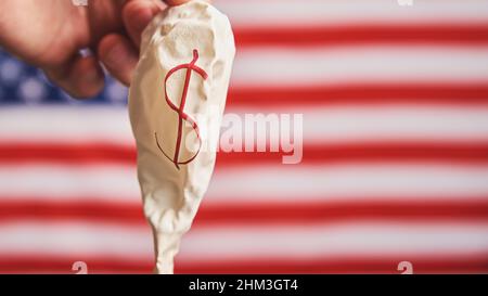 Deflated balloon with dollar sign on American flag background, USA economic crisis and inflation concept Stock Photo