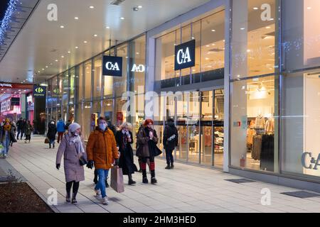 Warsaw, Poland - January 8, 2022: Entrance to the C&A store at Marszalkowska street in the city center at night. Stock Photo