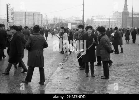 The 60th anniversary of the October Revolution. People come out of Red Square after the parade. Moscow, Russia, USSR, November 7, 1977 Stock Photo