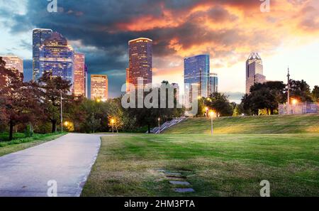 Houston Texas modern skyline at sunset twilight from park lawn Stock Photo