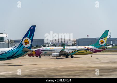 Nok Air passenger planes parked at Don Mueang International Airport (DMK) in Bangkok.In addition to the resumption of 'Test & Go,' a program for fully-vaccinated tourists to enter the country quarantine-free, the Thai cabinet approved a 9 Billion THB budget to extend its domestic tourism stimulus scheme for the fourth time since the onset of the COVID-19 pandemic. The 'We Travel Together' program offers Thai nationals a travel subsidy for accommodation and food on domestic trips. Stock Photo