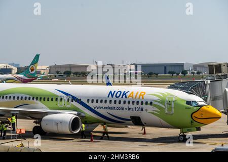 Nok Air passenger plane parked at Don Mueang International Airport (DMK) in Bangkok.In addition to the resumption of 'Test & Go,' a program for fully-vaccinated tourists to enter the country quarantine-free, the Thai cabinet approved a 9 Billion THB budget to extend its domestic tourism stimulus scheme for the fourth time since the onset of the COVID-19 pandemic. The 'We Travel Together' program offers Thai nationals a travel subsidy for accommodation and food on domestic trips. Stock Photo