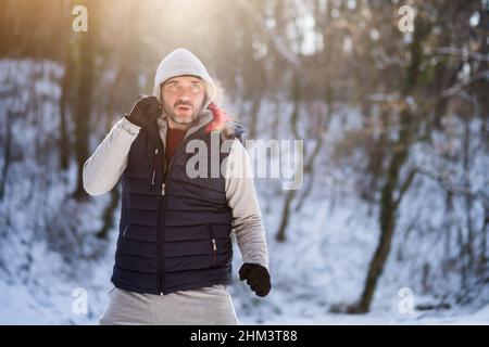 Boxer is training in park in winter. He is working on his fitness. Stock Photo