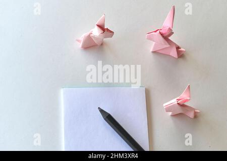 Happy easter paper card. Easter bunnies. Handicraft origami rabbits from paper Stock Photo