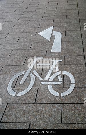 Bicycle marking on the road with an arrow to turn left Stock Photo