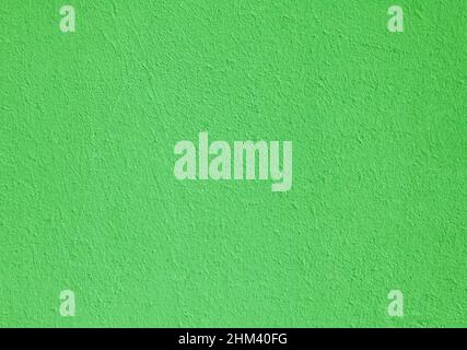 Green textured wall, texture, background. Structural plaster, covered with water-based paint. Plane, uneven surface in green color Stock Photo