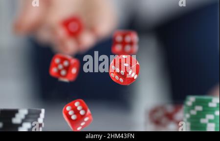 Red dice flying over casino chips closeup Stock Photo
