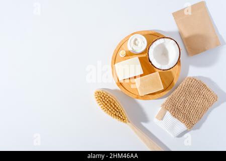 top view eco body care, natural soap, dry massage brush , cream, washcloth on white background Stock Photo