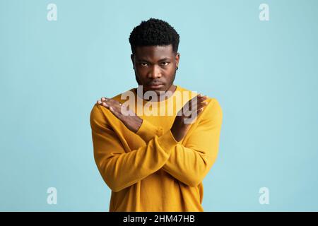 Serious african american guy in casual saying no Stock Photo