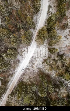 Aerial view of a snow-covered rural landscape with frost-covered trees ...