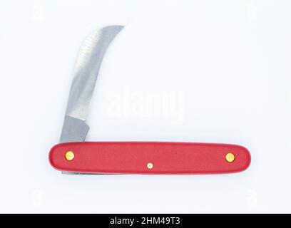 Red handle folding knife isolated on white background. Stock Photo