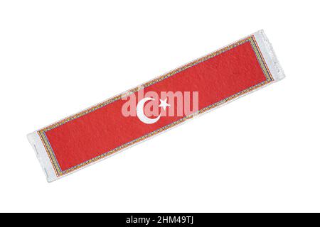 Flag of Turkish on the carpet, isolated on white background. The flag of the Republic of Turkey. Stock Photo