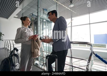 Tourist couple with luggage standing in corridor Stock Photo
